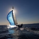 people riding on sailboat on sea during daytime