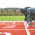 man in black and red plaid shirt and black pants standing on track field during daytime, Atletica Punto It Cesano Boscone