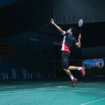 man in white and red crew neck t-shirt and black shorts playing basketball, Matex Mara campione badminton