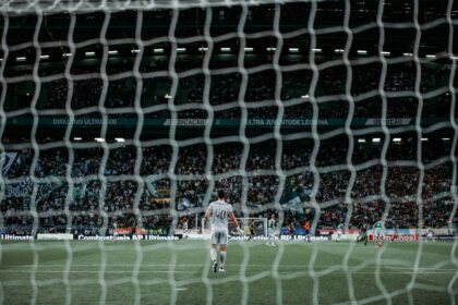 man standing on green soccer field