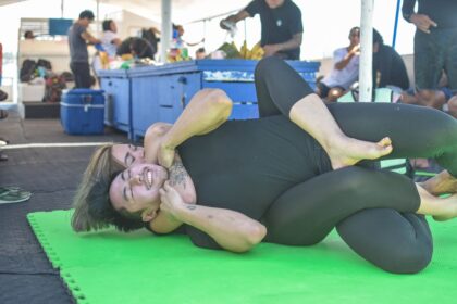 woman in black tank top lying on green floor corsi sumo Milano