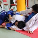 girl and boy doing Brazilian jiu-jitsu sumo e preparazione atletica