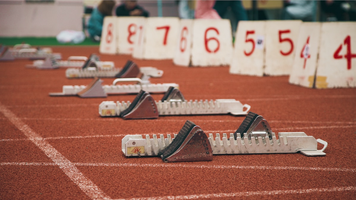 a row of tennis racquets sitting on a tennis court