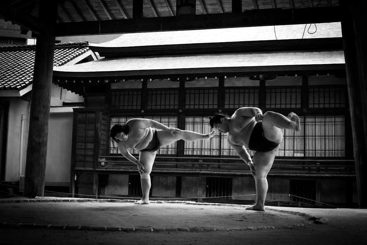 A couple of women standing next to each other in front of a building