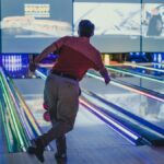 a man is bowling down a bowling alley bowling a Milano