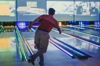 a man is bowling down a bowling alley bowling a Milano