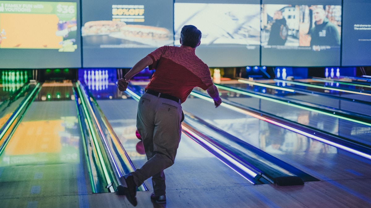 a man is bowling down a bowling alley bowling a Milano