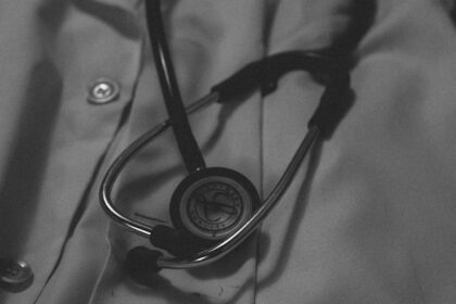 a black and white photo of a doctor's coat with a stethos
