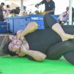 woman in black tank top lying on green floor