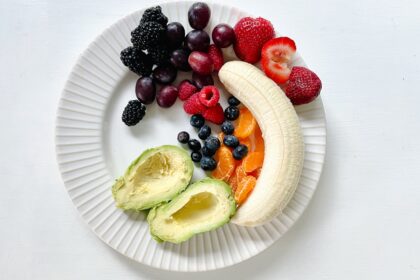 a white plate topped with fruits and vegetables