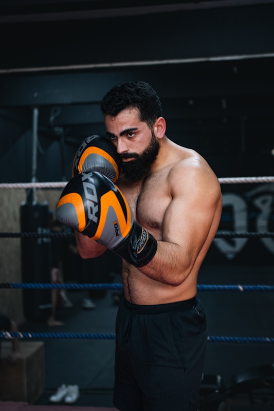 a man with a beard wearing boxing gloves
