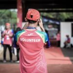 person standing wearing red shirt