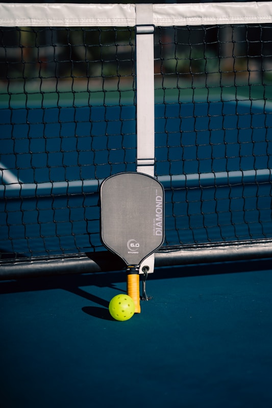 A tennis ball and racket on a court