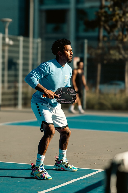 A man standing on a tennis court holding a tennis racquet