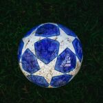 blue and white star print soccer ball on grass